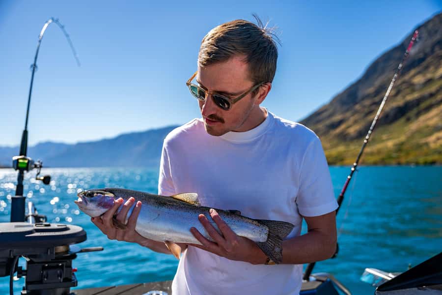Lake Wakatipu: 3 Hour Fishing Adventure by Boat - Meeting the blue Catch a Fish boat at the jetty